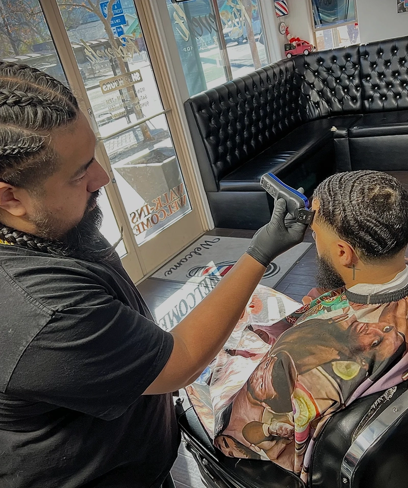 Barber styling hair with clippers