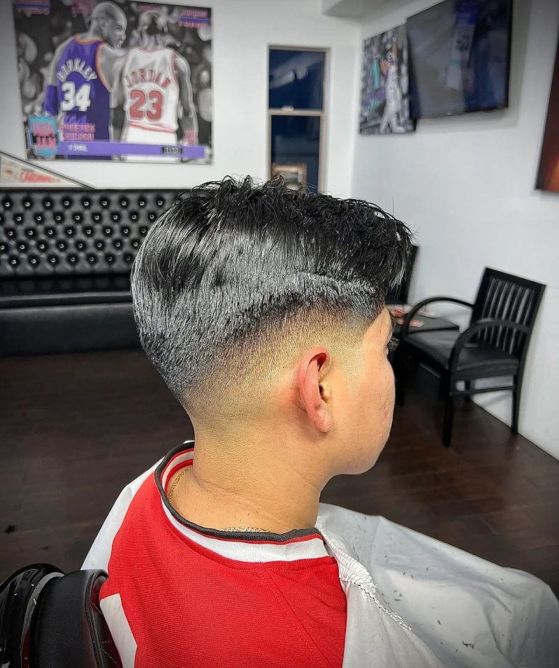 Stylish fade haircut in modern barbershop