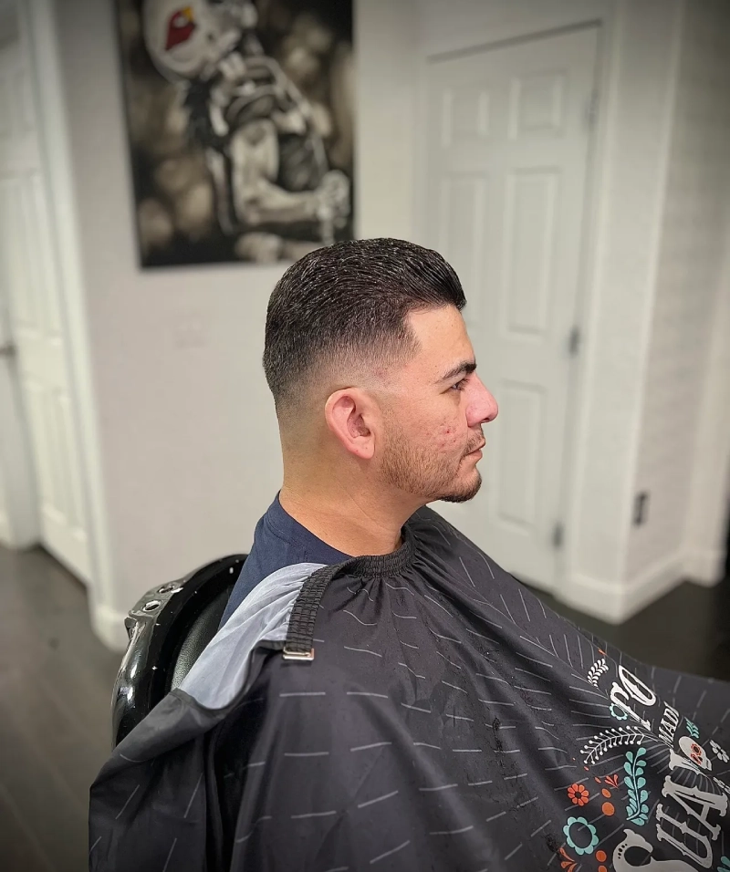 Man with fresh fade haircut in salon chair