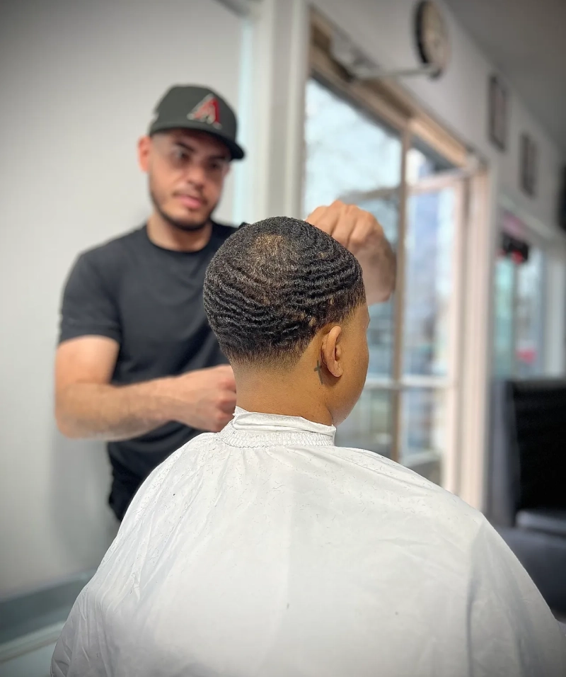 Barber styling a man's hair