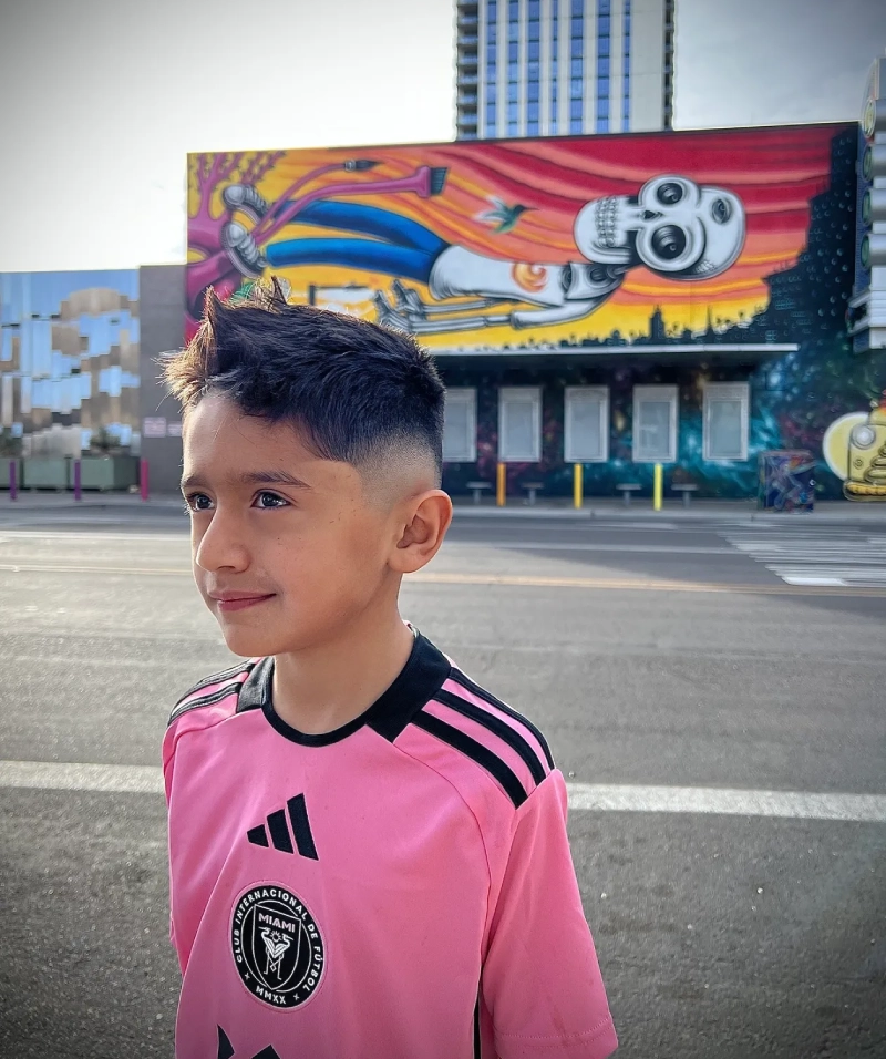 Boy standing in front of street art